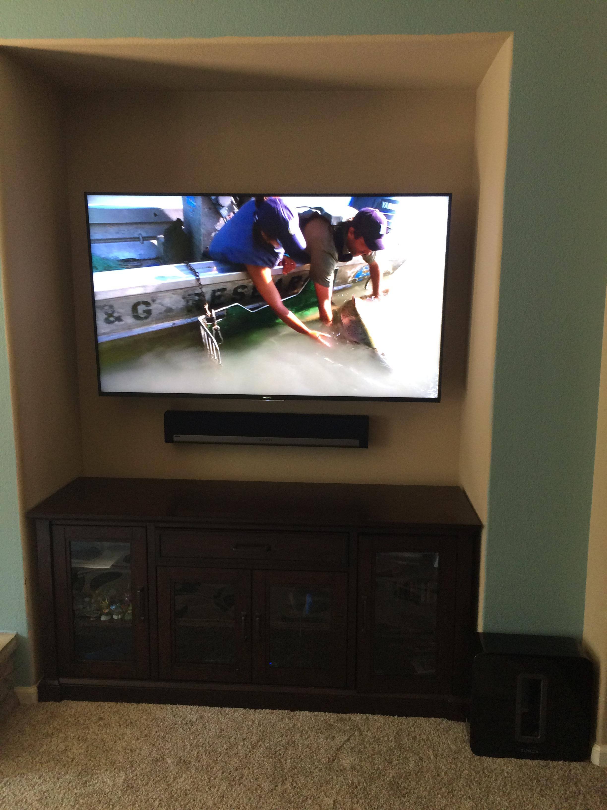 TV mounted on wall with play bar under, click to load a larger version