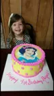 Birthday girl with her Snow White Cake, click to load a larger version