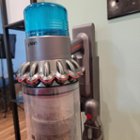Gen5outsize stored in mounted Wall dok for charging, with the wide nozzle/brush attached to the right-hand storage slot., click to load a larger version