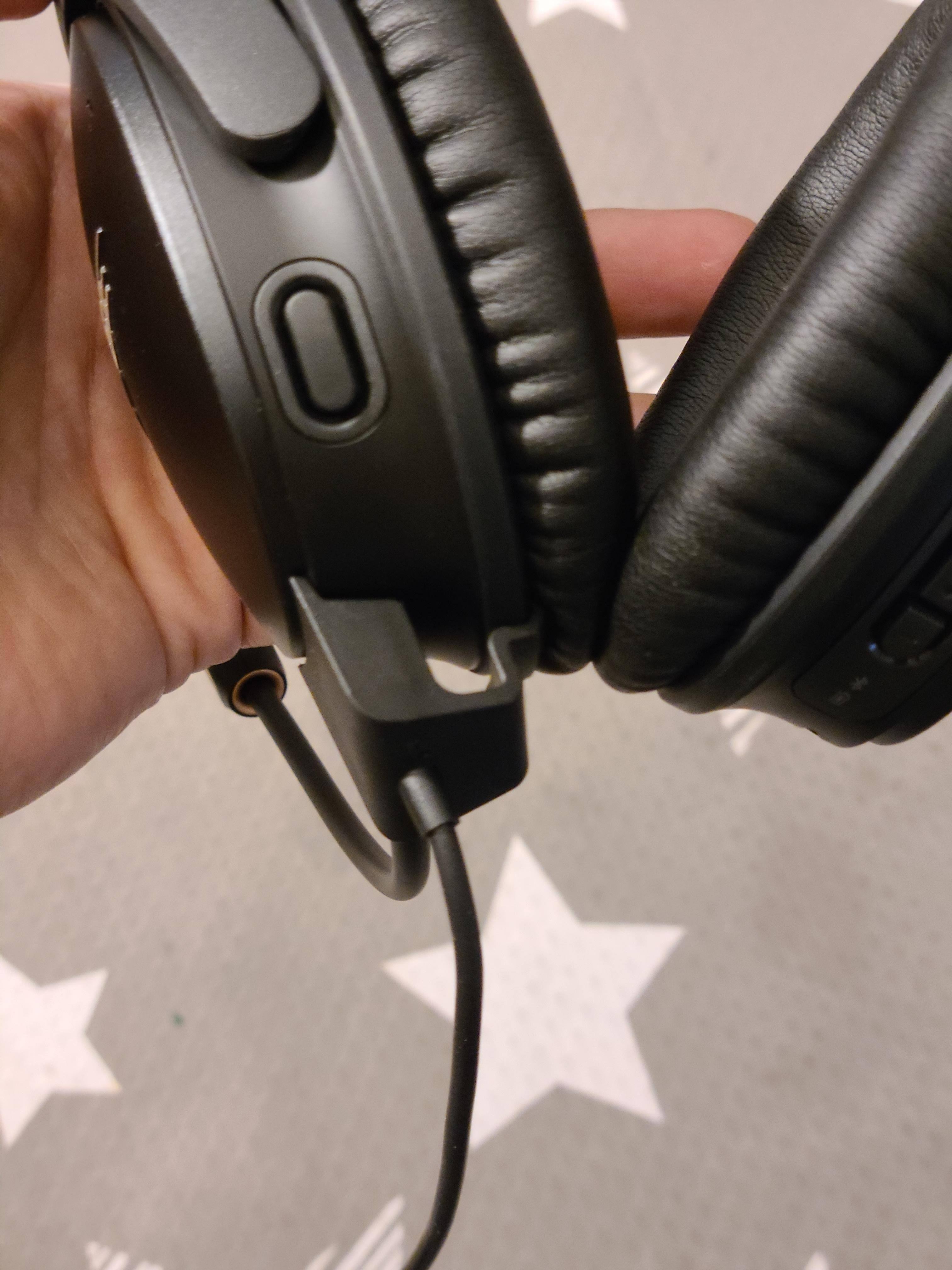 Pull back on the tab and yank it straight down to detach the boom mic., click to load a larger version