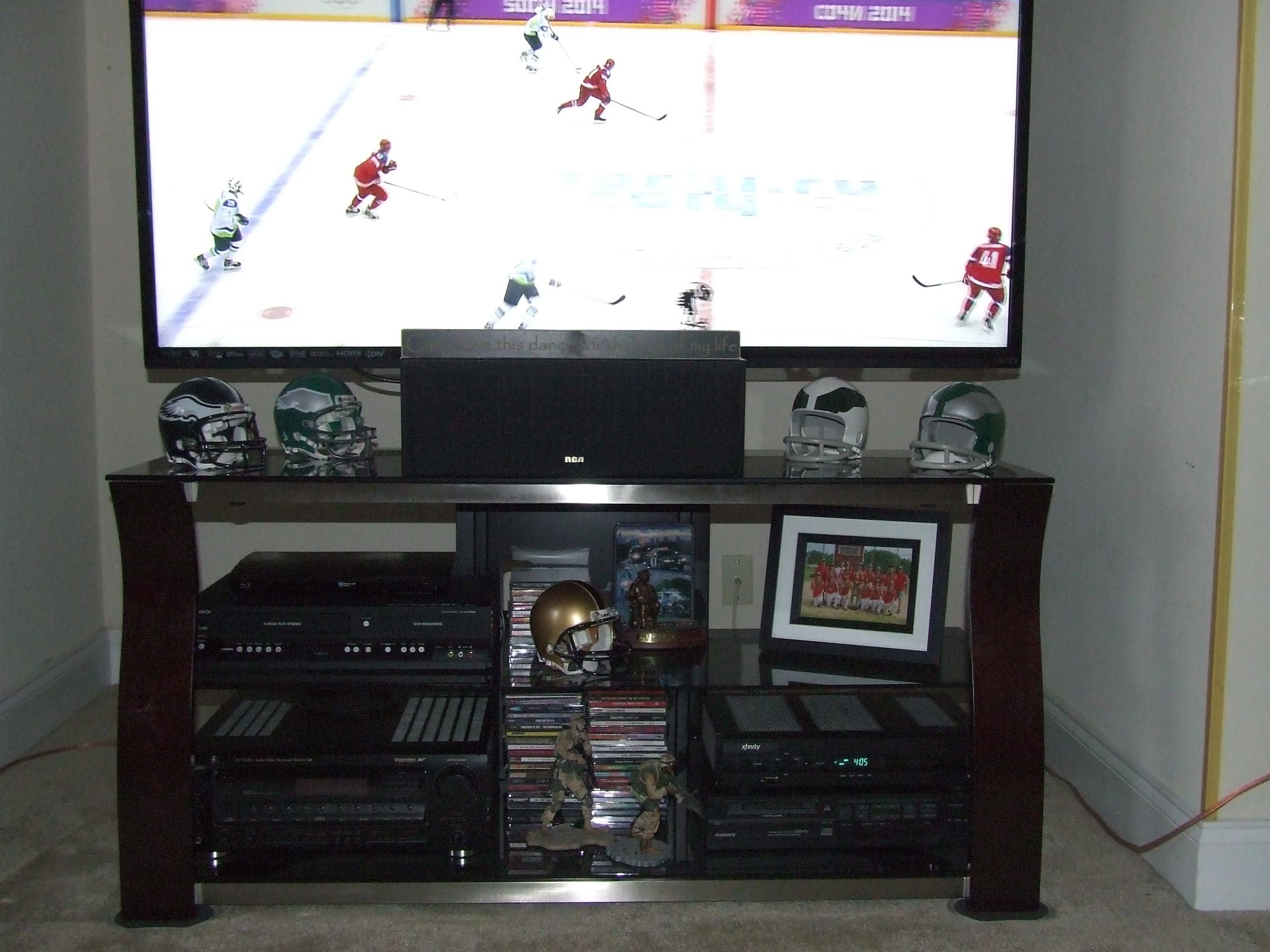 You can see the width of stand with 60" Led mounted, 2 rows of CD's in center of 4 audio components and room for large pic frame, click to load a larger version