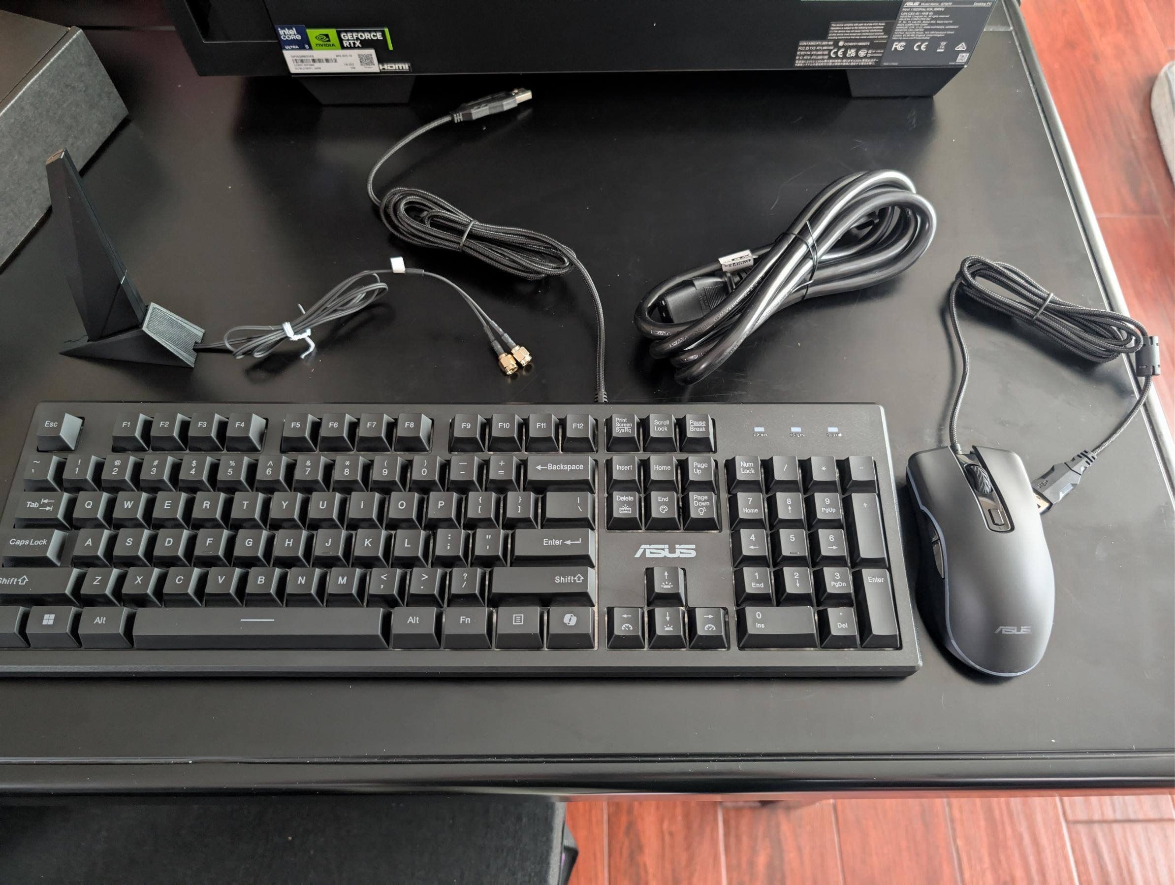 Boxed accessories, including keyboard, mouse, power cable, and external WiFi antenna., click to load a larger version