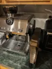 I was able to slide this just under my cabinet, and the water tank can be removed and carefully pulled forward without moving the machine after all.  It's not as convenient as some other coffee makers that put their designs on the side., click to load a larger version