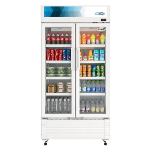The image features a refrigerator with a variety of drinks inside. There are multiple bottles of Coca-Cola, including some in the door compartments and others in the main compartment. Additionally, there are several bottles of Vitamin Water, with some placed in the door compartments and others in the main compartment. The refrigerator is filled with a wide assortment of drinks, making it a convenient place to store and access beverages.