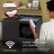 The image features a woman standing next to a washing machine, holding a cell phone. The text on the image reads: "ThinQ Smart Technology helps make life happen. Control your washer remotely and get real-time diagnostics and alerts with ThinQ technology." This text is promoting the ThinQ technology that allows users to control their washing machine remotely and receive real-time diagnostics and alerts.