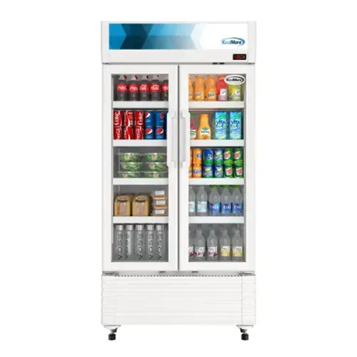 The image features a refrigerator with a variety of drinks inside. The drinks include several bottles of Coke, as well as a few bottles of Vitamin Water. The refrigerator is stocked with a diverse selection of beverages, making it an appealing option for those looking to quench their thirst.
