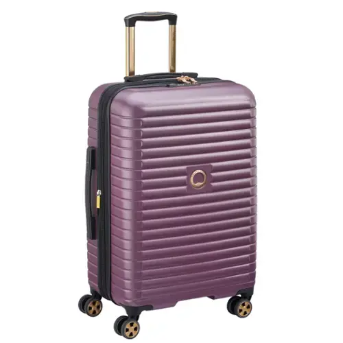 The image shows a purple, hard-shell suitcase with a gold-colored handle and wheels.